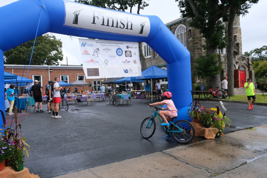 Kid on a bike crossing the Finish Line
